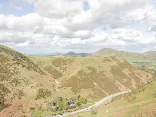 a view of a mountain with a road on it at Round House in Church Stretton