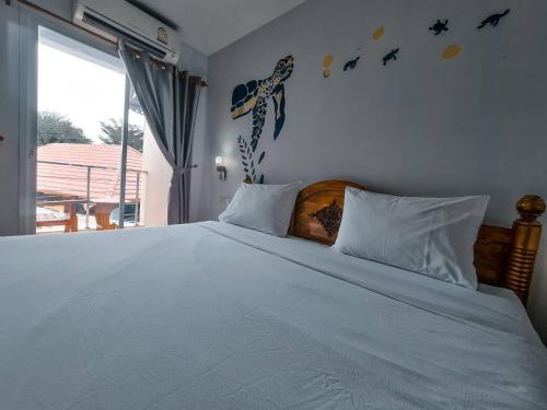 a bedroom with a large bed with white sheets at Euro Boutique Hotel in Chumphon
