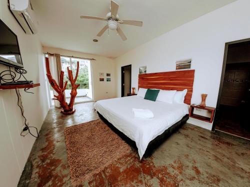 a bedroom with a bed and a ceiling fan at ME Hotel & Villas - Montañita Estates in Montañita
