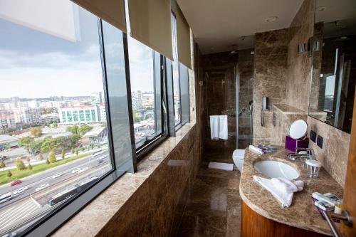 a bathroom with a sink and a large window at Uranus Istanbul Topkapi in Istanbul