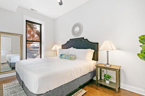 a white bedroom with a large bed and a window at Perfect Getaway 3BR Apartment - Newport 2 in Chicago