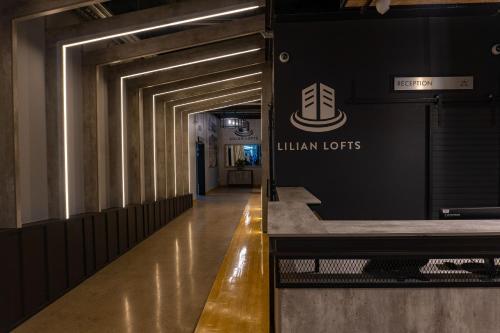 a hallway in a building with a sign on the wall at Lilian Lofts Hotel & Spa in Johannesburg