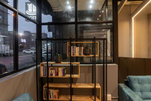 a book shelf with books on it next to a window at Lilian Lofts Hotel & Spa in Johannesburg