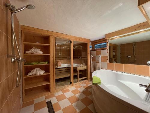 a bathroom with a large tub and a shower at Sporthotel Schulenberg in Schulenberg im Oberharz