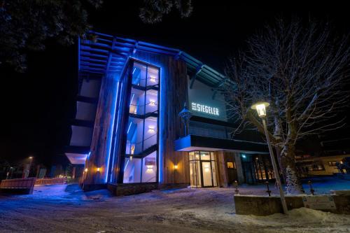 a building with blue lights on it at night at Der Siegeler B&B - this lifestylehotel rocks in Mayrhofen
