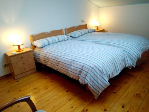 a bedroom with a bed with two night stands and two lamps at 2 bedrooms apartement at Llanes 200 m away from the beach with wifi in Llanes