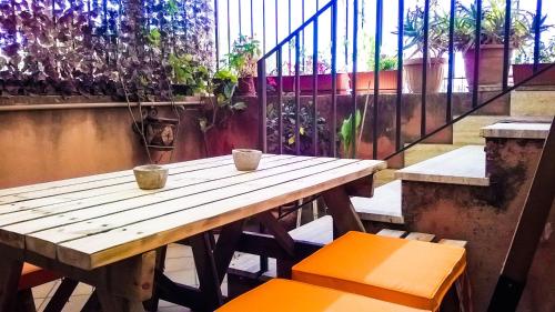a wooden table with two cups and two chairs at Spacious Apartment in Realmonte, Sea View in Realmonte