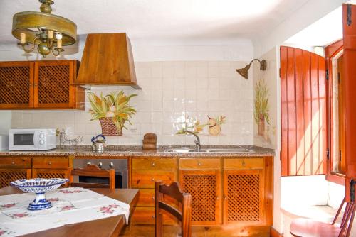 A kitchen or kitchenette at 3 bedrooms house with shared pool garden and wifi at Porto de Mos