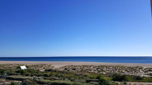 a view of a beach with the ocean in the background at Appartement confortable avec vue sur la mer à Port Leucate, 50 m² in Leucate