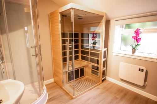 a bathroom with a shower and a toilet and a sink at The View 3-Bed Cottage Findochty Buckie Moray in Findochty