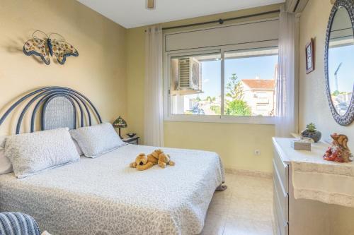 a bedroom with a bed with a teddy bear on it at Modern villa with pool in Torredembarra - Sea view in Torredembarra