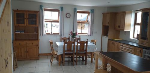 a kitchen with a table and chairs in it at Murphy's Irish farmhouse near Ballybunion in Ballybunion