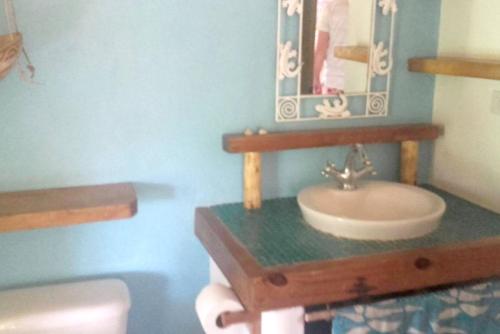 a bathroom with a sink and a mirror at Welcoming House in Las Galeras with Stunning Sea View in Las Galeras