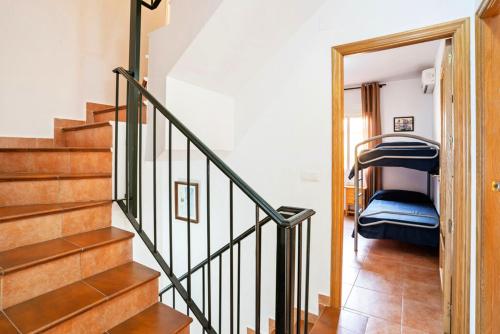 a staircase in a house with a bunk bed at Inviting house in Lepe with shared pool. in Lepe