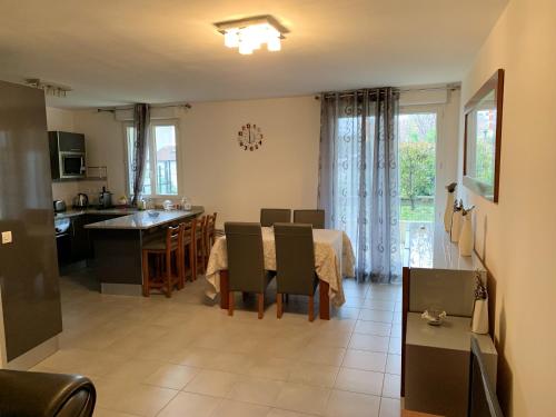 a kitchen and living room with a table and a dining room at Appartement de 2 chambres avec terrasse et wifi a Bagnolet in Bagnolet