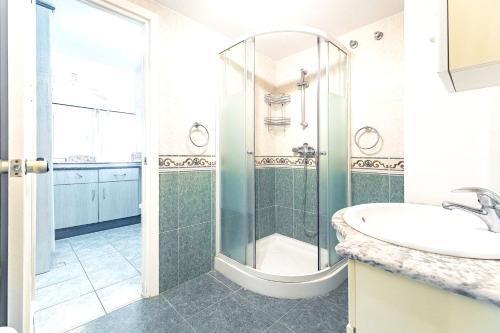 a bathroom with a shower and a sink at Sea View Apartment in Benalmádena, Shared Pool in Benalmádena