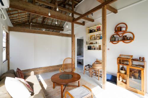 a living room with a couch and a table at irregular INN Nakijin in Nakijin
