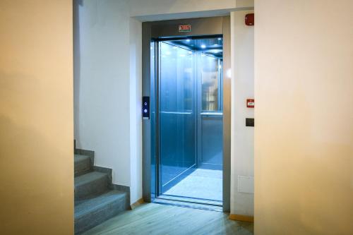 a glass door leading into a hallway with stairs at Agriturismo Cà Gianin in Vervio