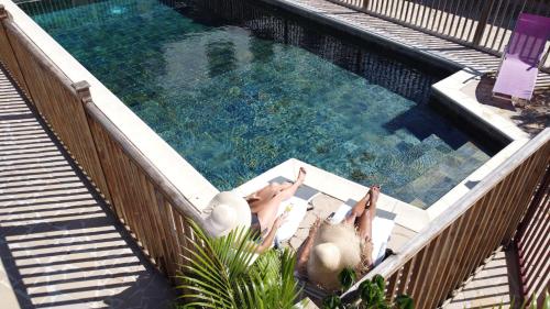 a group of people laying in a swimming pool at Domaine du Château in Les Trois-Îlets
