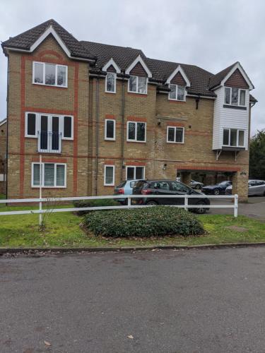 a large brick house with a car parked in front of it at Oaklawn Apartment - Sleeps 4 Parking & Garden in Woking