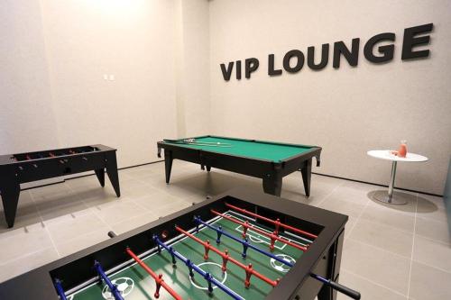 two ping pong tables in a room with a sign at Astron Suítes Mondial Salvador by Nobile in Salvador