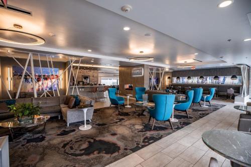 a hotel lobby with blue chairs and a bar at Hotel Indigo Harrisburg - Hershey by IHG in Harrisburg