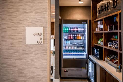 a refrigerator with a sign that reads grand and go at Hotel Indigo Harrisburg - Hershey by IHG in Harrisburg