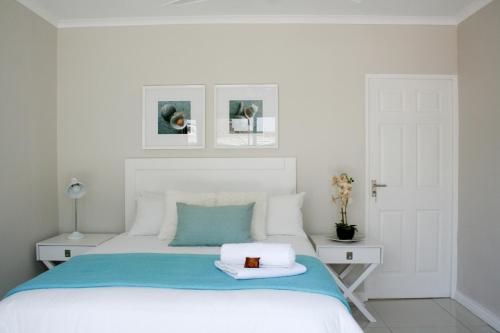 1 dormitorio con cama blanca y manta azul en Summit Place, en East London