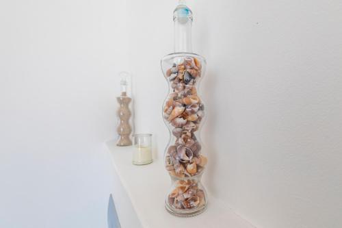 a glass vase filled with rocks on a wall at 189 Casa Del Playa in Yzerfontein