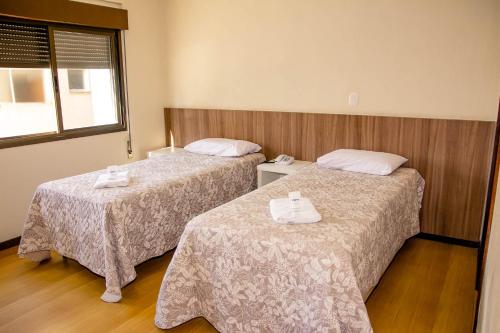 Ένα ή περισσότερα κρεβάτια σε δωμάτιο στο Hotel Letto Caxias