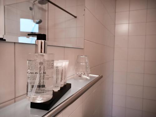 a bottle of soap sitting on a shelf in a bathroom at Hotel Anne-Klare in Joure