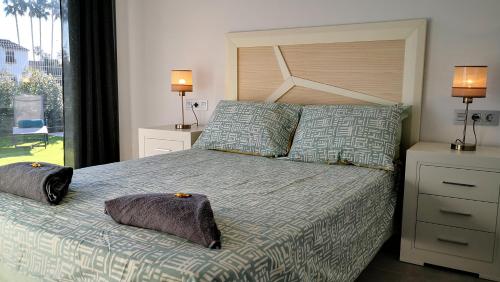 a bedroom with a bed with two pillows on it at Casa Blanco - Luxury Detached Villa in San Javier