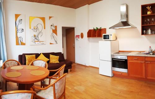 a kitchen and a living room with a table and a couch at ELENA flat Tulpe Duisburg Zentrum in Duisburg