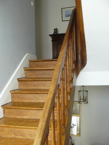 a wooden staircase in a home with a wooden railing at La Maison de Saumur in Saumur