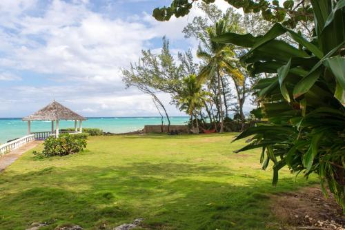 a grass field with a gazebo and the ocean at Villa Viento in St Mary
