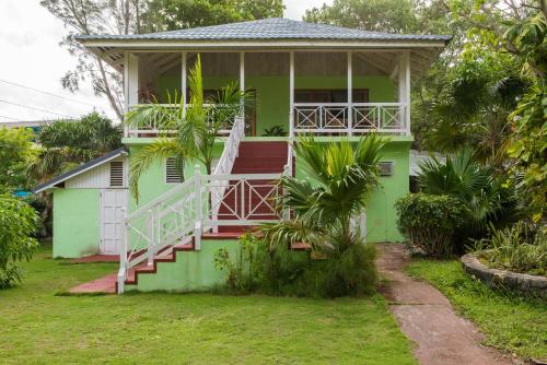 a green house with a staircase in front of it at Villa Viento in St Mary