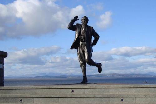 a statue of a man jumping in the air at Cosy 2-Bed Apartment near the beach in Morecambe in Morecambe