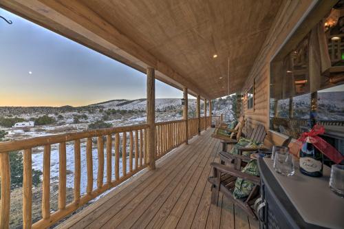 a porch with a view of the water and snow covered mountains at Peaceful Cabin with Panoramic Mtn Views and Hot Tub! in Del Norte