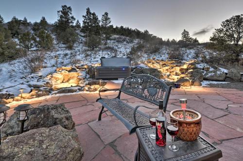 a bench with two glasses of wine and a grill at Peaceful Cabin with Panoramic Mtn Views and Hot Tub! in Del Norte