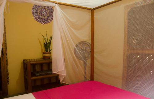 Postel nebo postele na pokoji v ubytování Hostal Corazón de Tagua