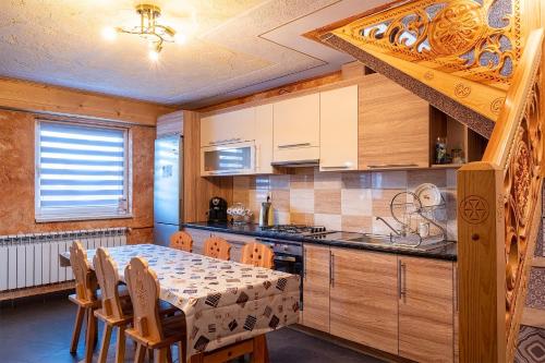 a kitchen with a table and a table and chairs at Agroturystyka Piekielnik in Piekielnik