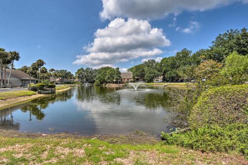 a river in a park with trees and clouds in the sky at Coastal Resort Beach Villa Less Than 1 Mi to Shore! in Hilton Head Island