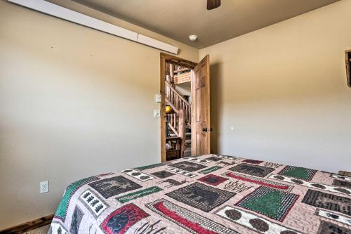 a bedroom with a bed with a quilt on it at Scenic Hill City Cabin Hiking and ATV Trail Access in Hill City