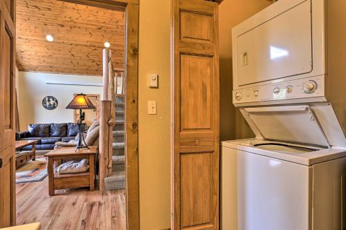 a kitchen with a washer and dryer and a living room at Scenic Hill City Cabin Hiking and ATV Trail Access in Hill City