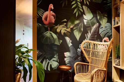 a room with two chairs and a wall with plants at Hotel Indigo Antwerp City Centre by IHG in Antwerp