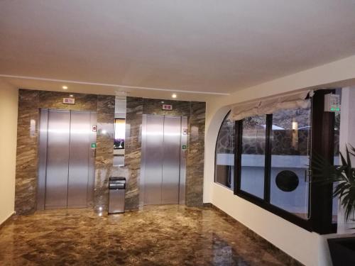 a elevator lobby with two elevators in a building at Patalavaca, aguamarina in Patalavaca