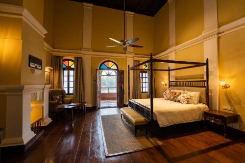 a bedroom with a bed and a ceiling fan at Taj Kumarakom Resort and Spa Kerala in Kumarakom