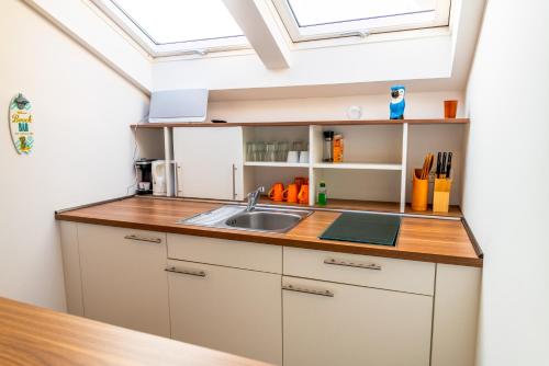 a kitchen with a sink and a skylight at Seaside-Townhouse in Timmendorfer Strand