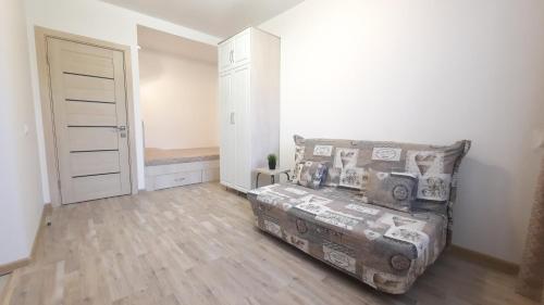 a small bedroom with a bed and a closet at Apartaments at Pan Kalinovsky in Pyatigorsk