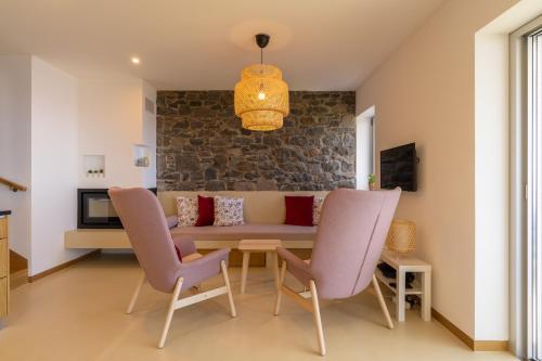 a living room with a couch and chairs at Villa Flora - Nature & Tranquility - Heated pool optional in Jardim do Mar